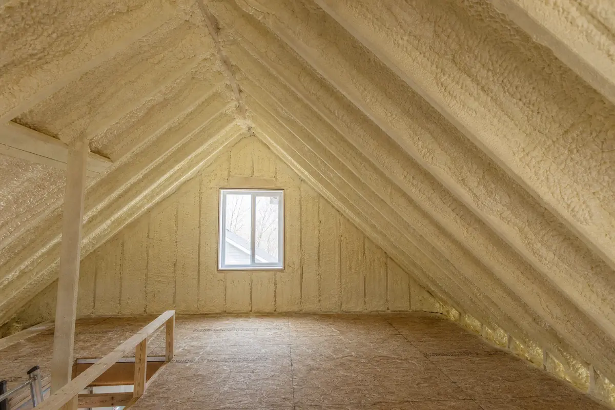 Closed-cell spray foam covering the rafters and gable of a Winnipeg attic